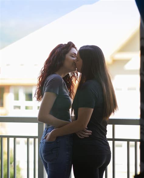 Authentic LGBT female lesbian couple kissing each other in slow。